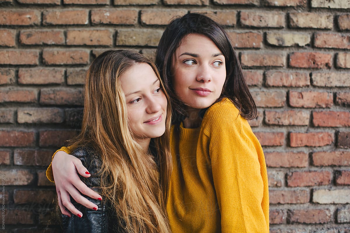 Best Friends Together In Front Of A Brick Wall By Stocksy Contributor Bonninstudio Stocksy