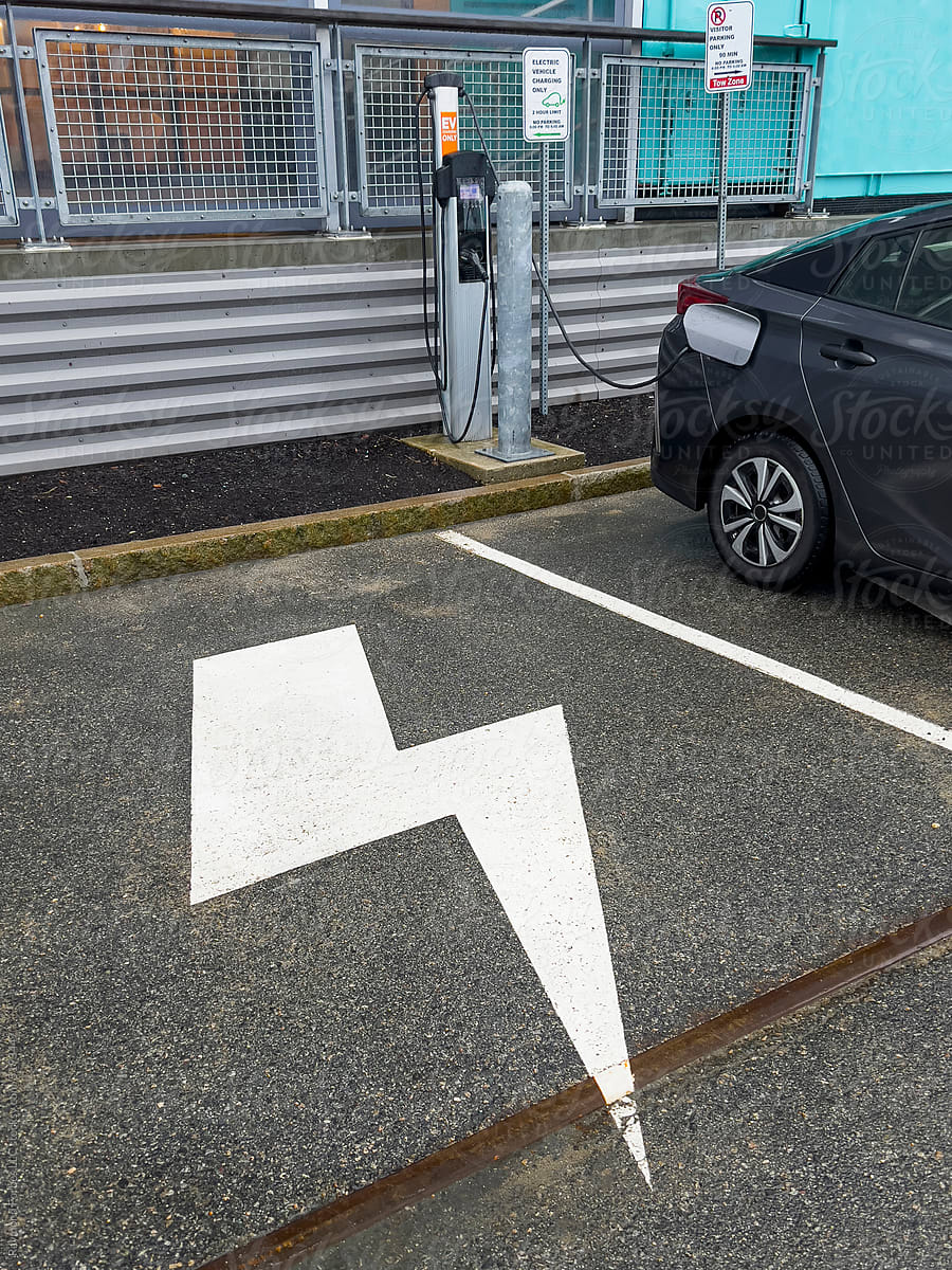 Electric car charging at designated charging station