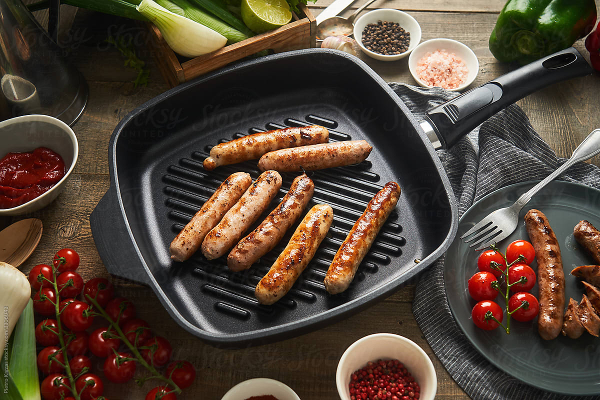 Grilled sausages on pan in kitchen