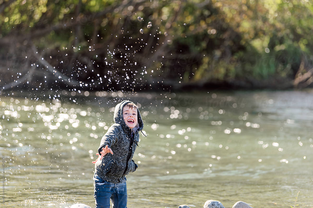 Child Playing In A Water By A River» del colaborador de Stocksy «Angela  Lumsden» - Stocksy