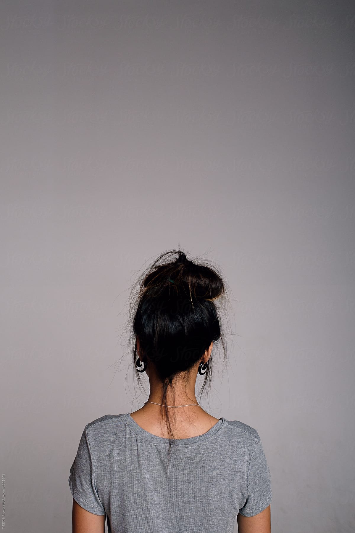 Back View Of Brunette Girl With Hairstyle Against Of Grey Background By Danil Nevsky