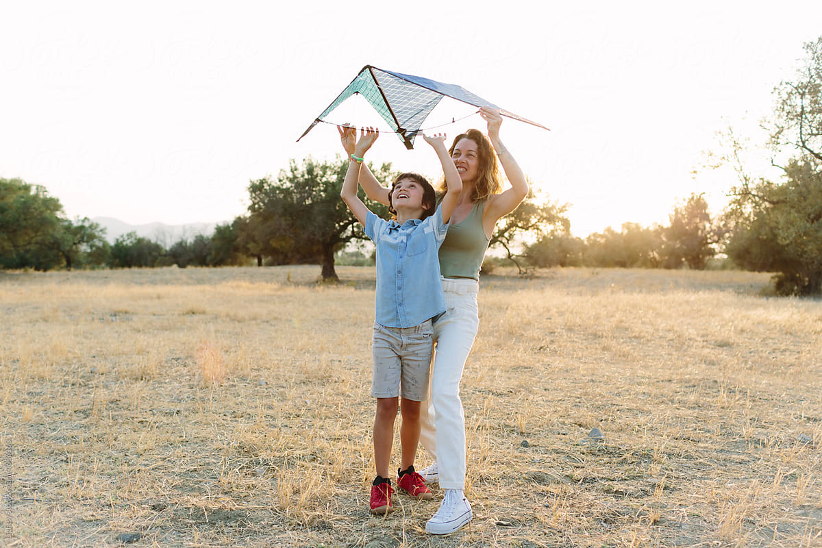 Mother and son making fly a kite