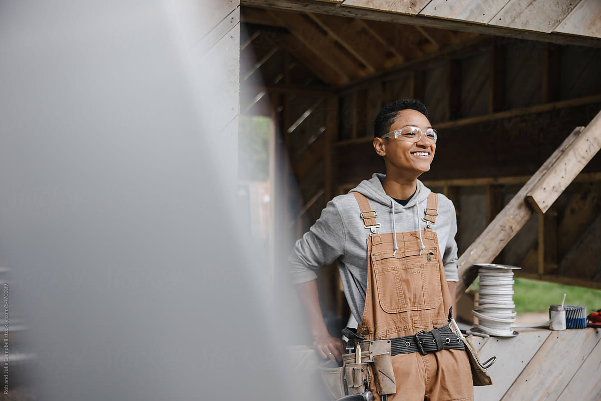 Candid laughing portrait of female carpenter on the jobsite.