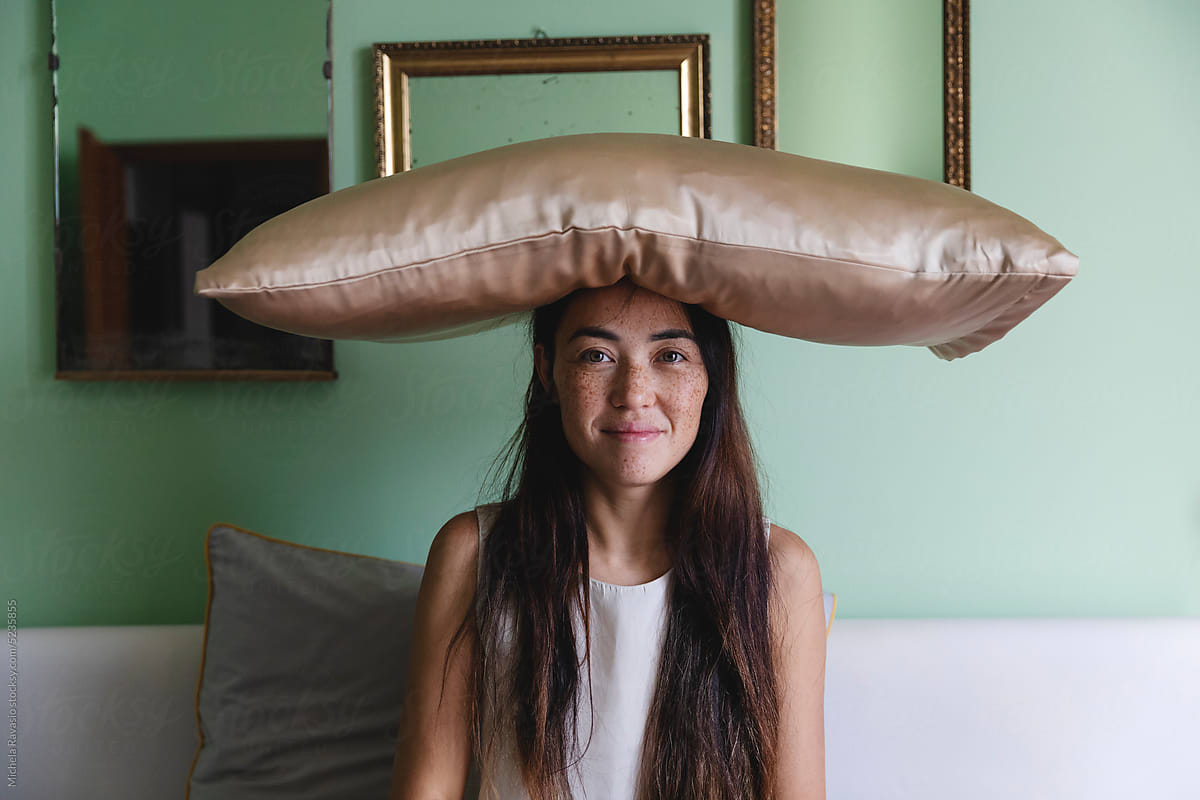 Woman with a pillow on her head