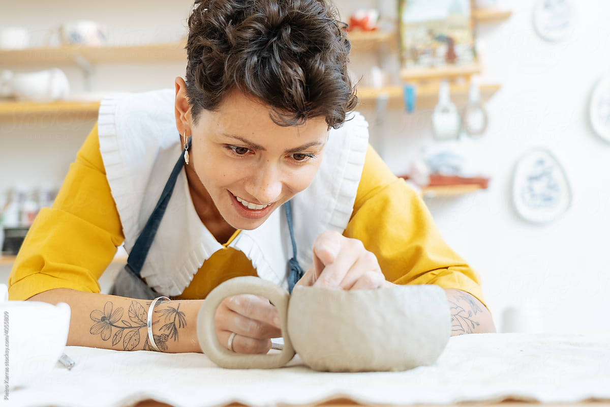 Ceramist woman working with clay at studio
