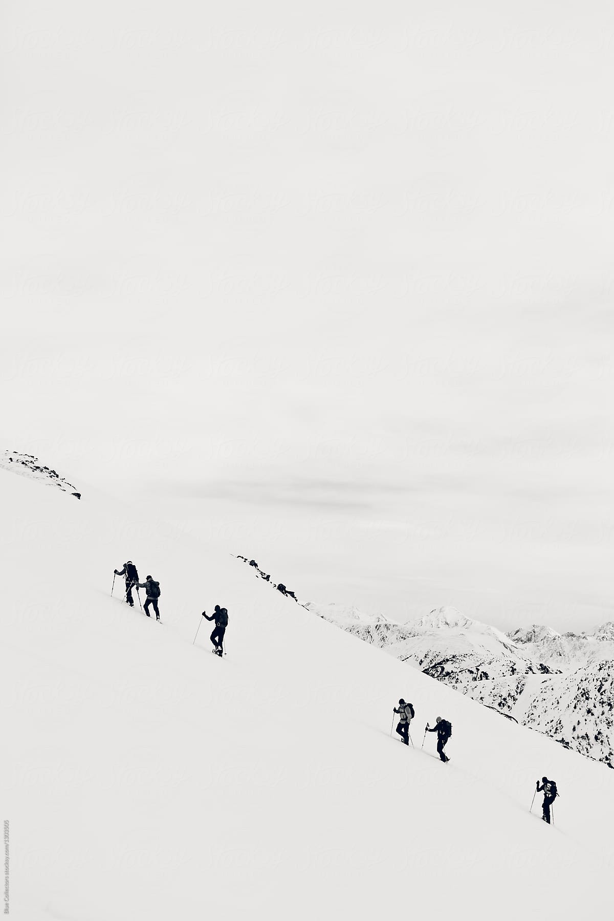 Group of mountaineers walking towards snowy mountains in the Pyrenees