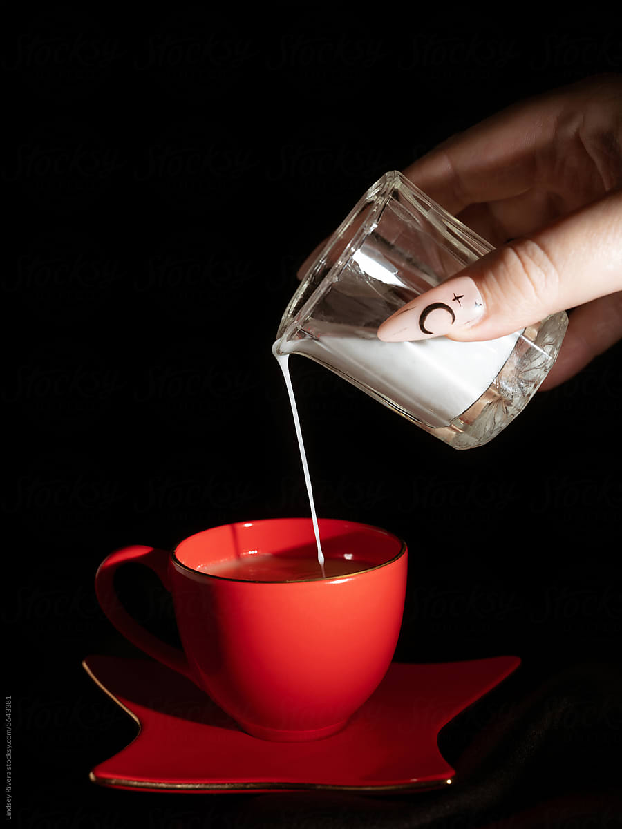 Pouring Creamer into Coffee