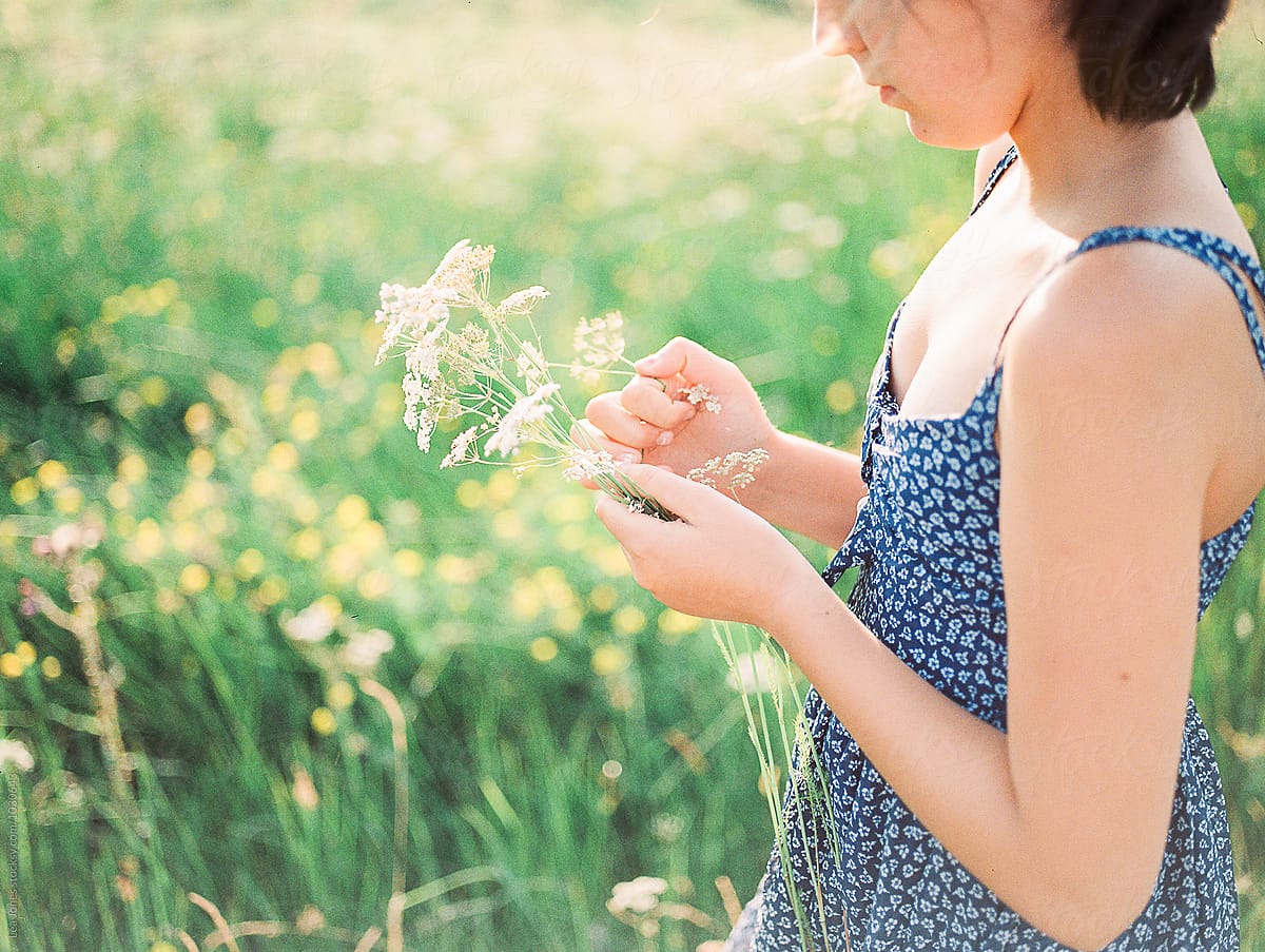 young girl picking flowers