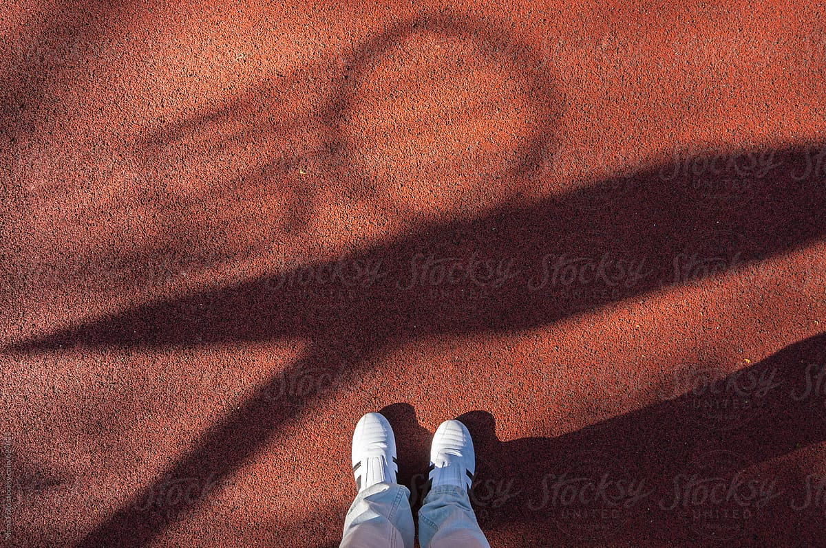 White sneakers, basketball shadow, footsie, personal perspective