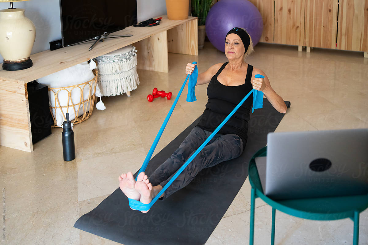 Mature woman working out with elastic band