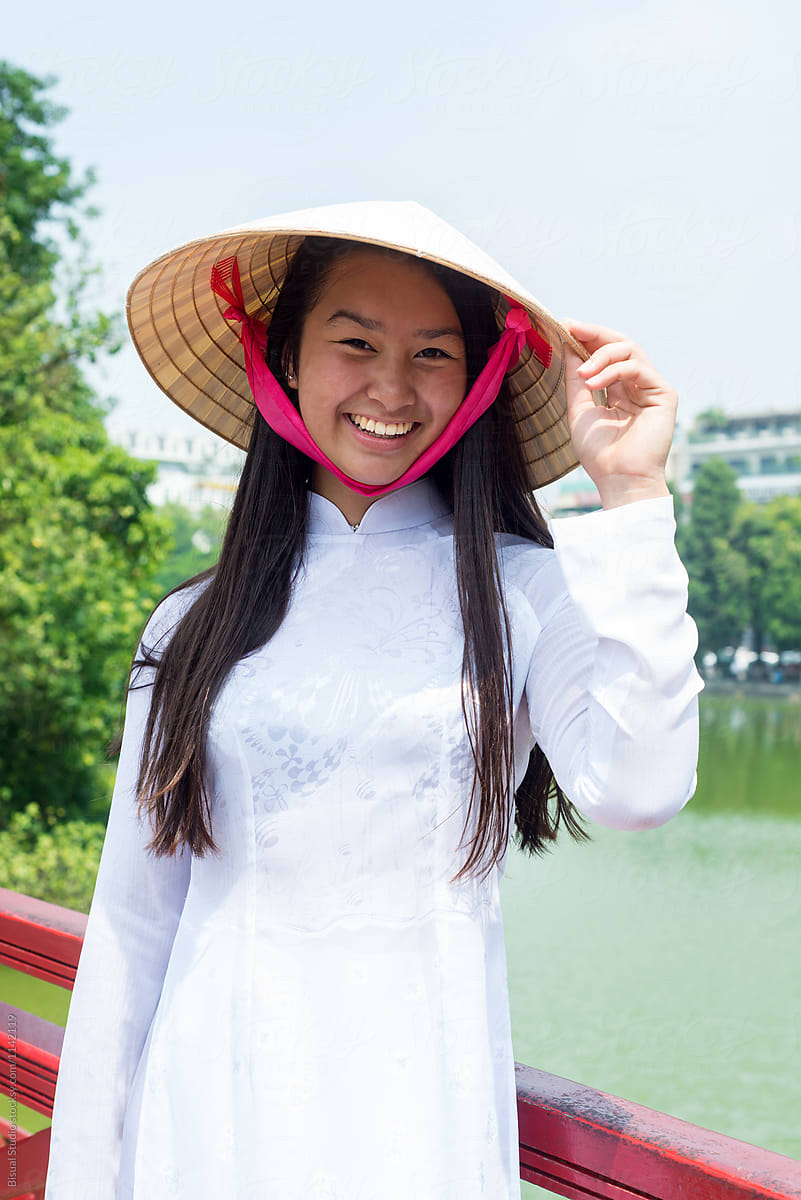 Happy Asian woman near lake