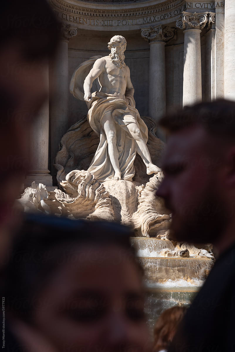 Trevi Fountain Triton sculpture with anonymous crowd