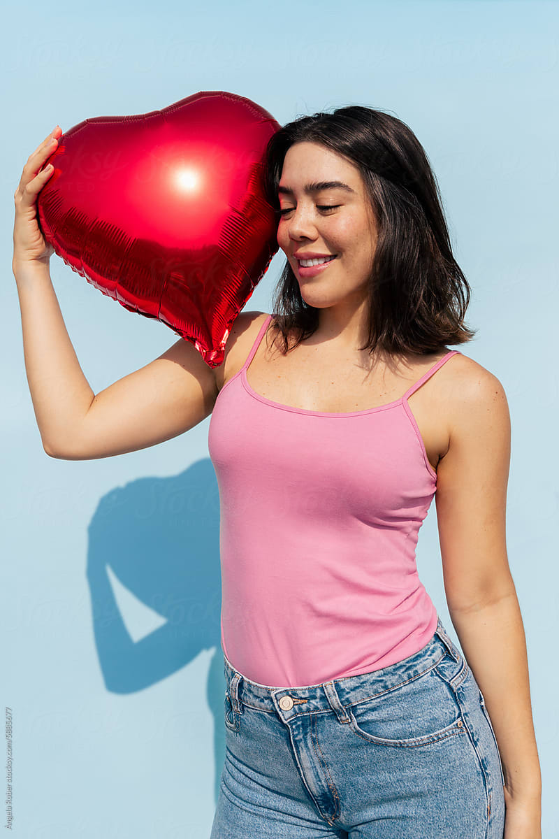Woman Holding a Heart-Shaped Balloon