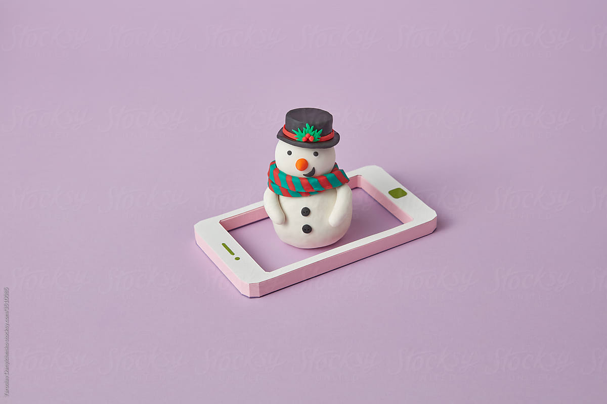 Craft plasticine Snowman figure on a smartphone frame.