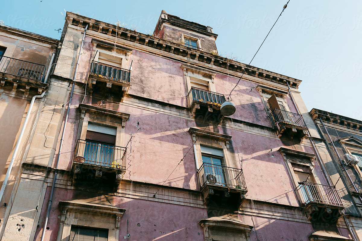 Facade of residencial building in old Italian city in sunlight.