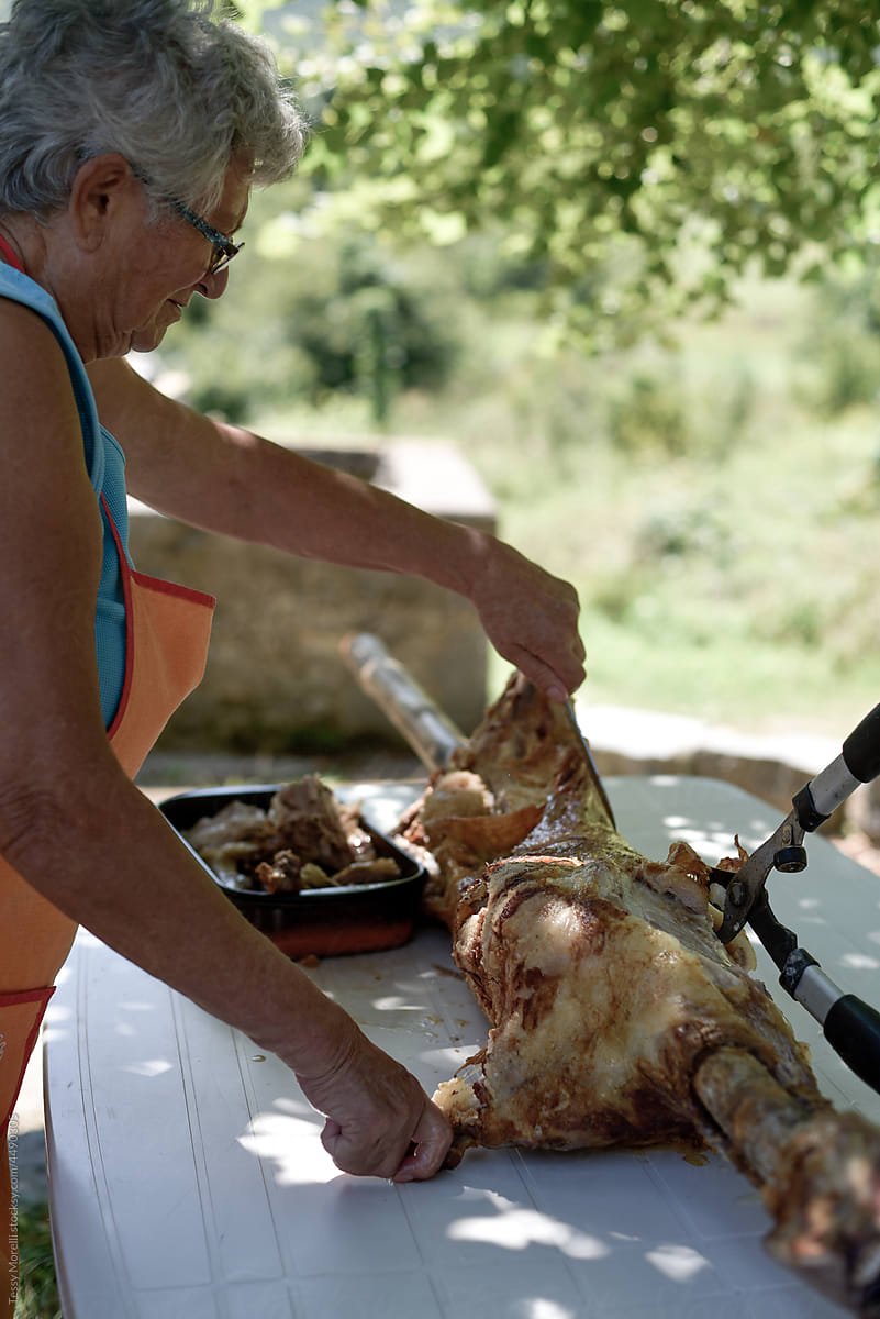 Woman candid scene with roasted lamb