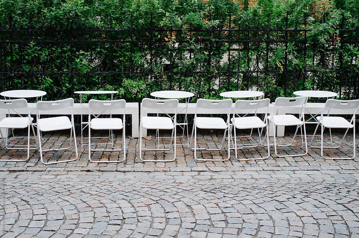 Row of white chairs and tables