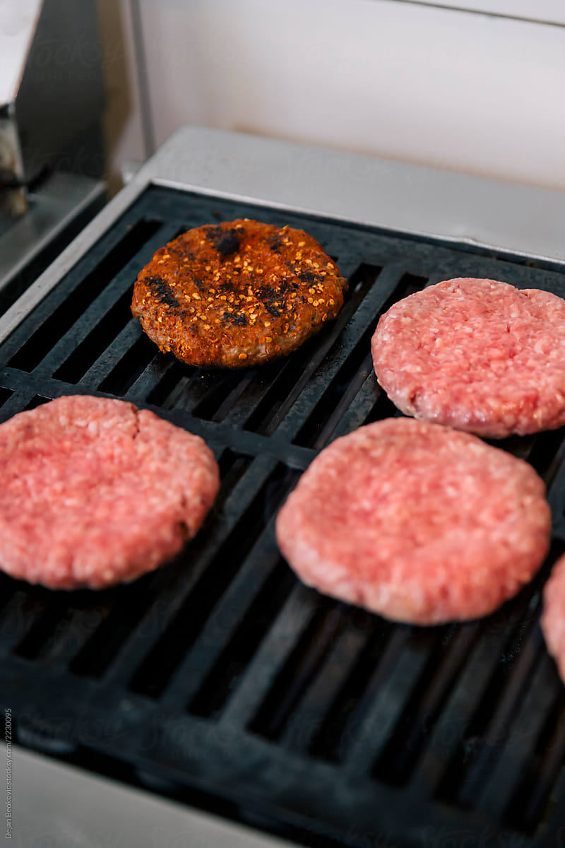 Minced meat on grill for burgers