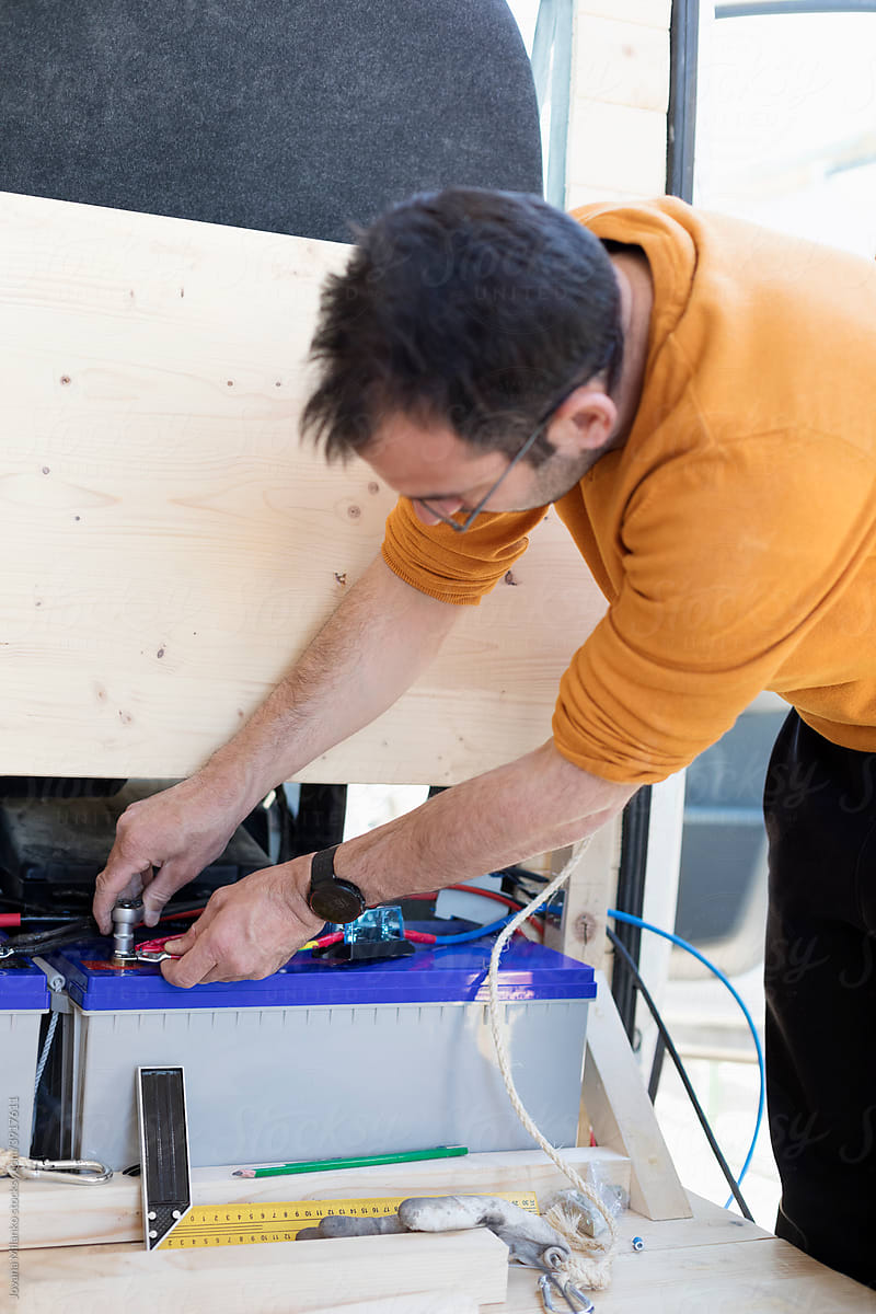 Man Connecting Van Accumulator Battery for Solar Panel