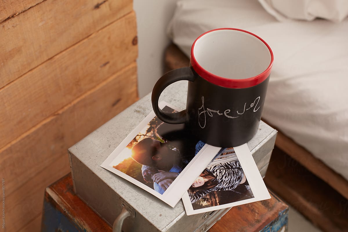 Close up of a mug on a table bedroom with the word forever written on it