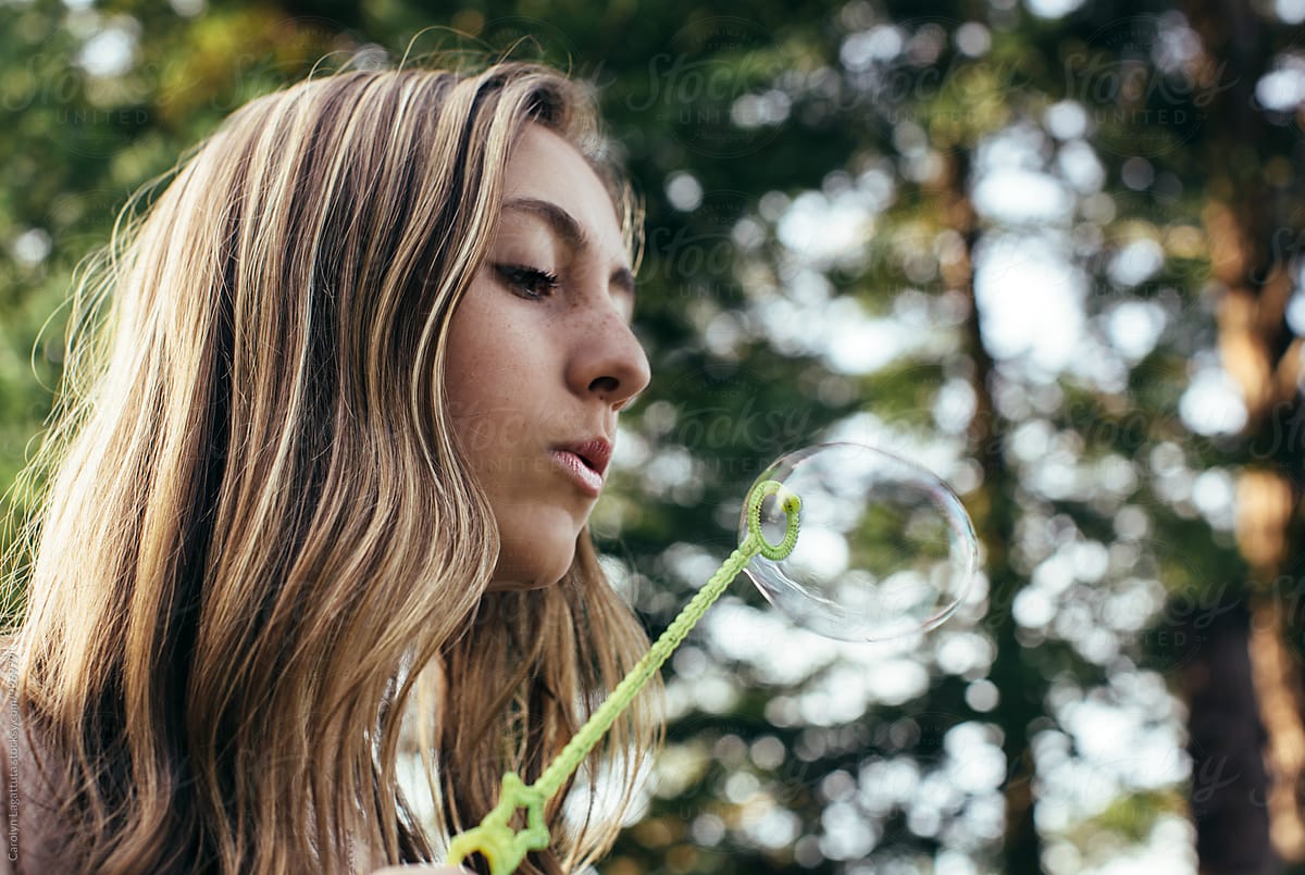 Beautiful Teenage Girl Blowing Bubbles Del Colaborador De Stocksy