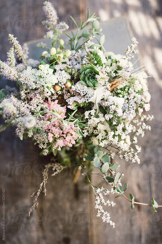 Beautiful pastel flower bouquet on a wooden background