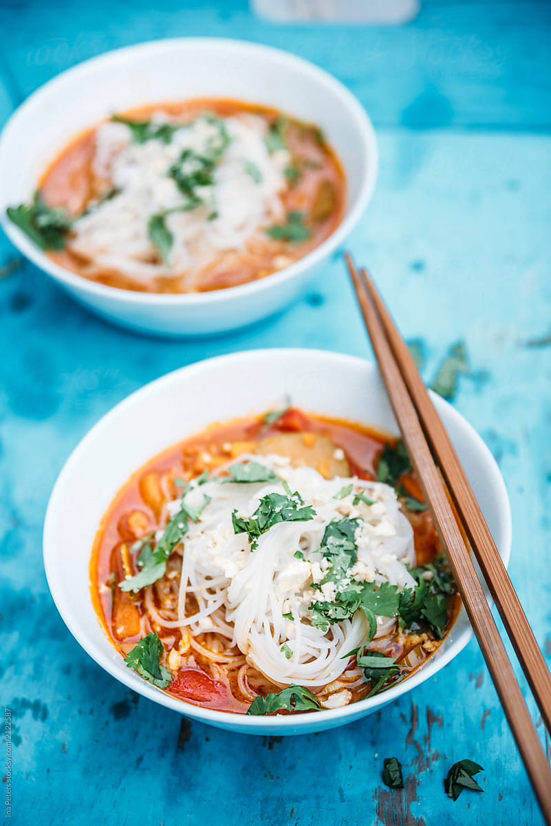 Food: Spicy thai soup with red curry, coconut milk, vegetables a