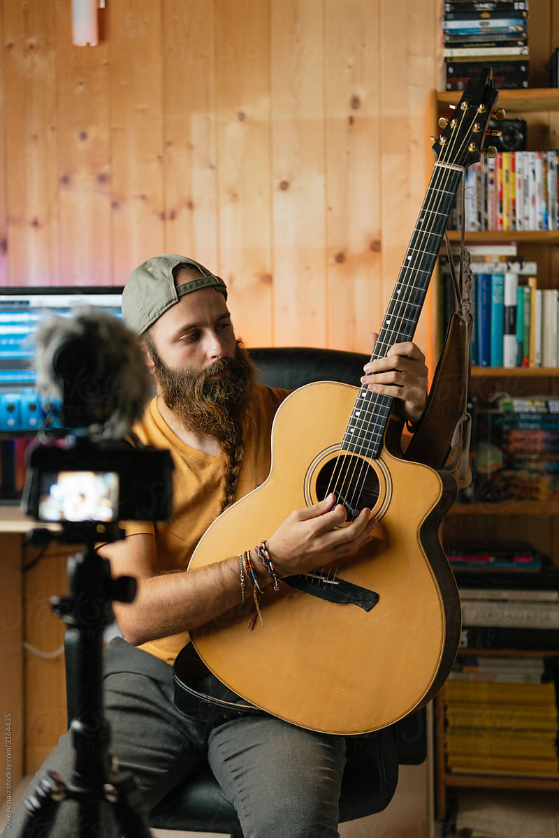 Man shooting a video playing guitar