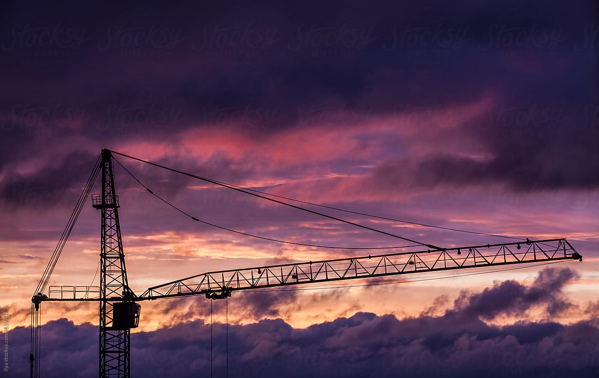 Building site crane silhouette dramatic sunset sky