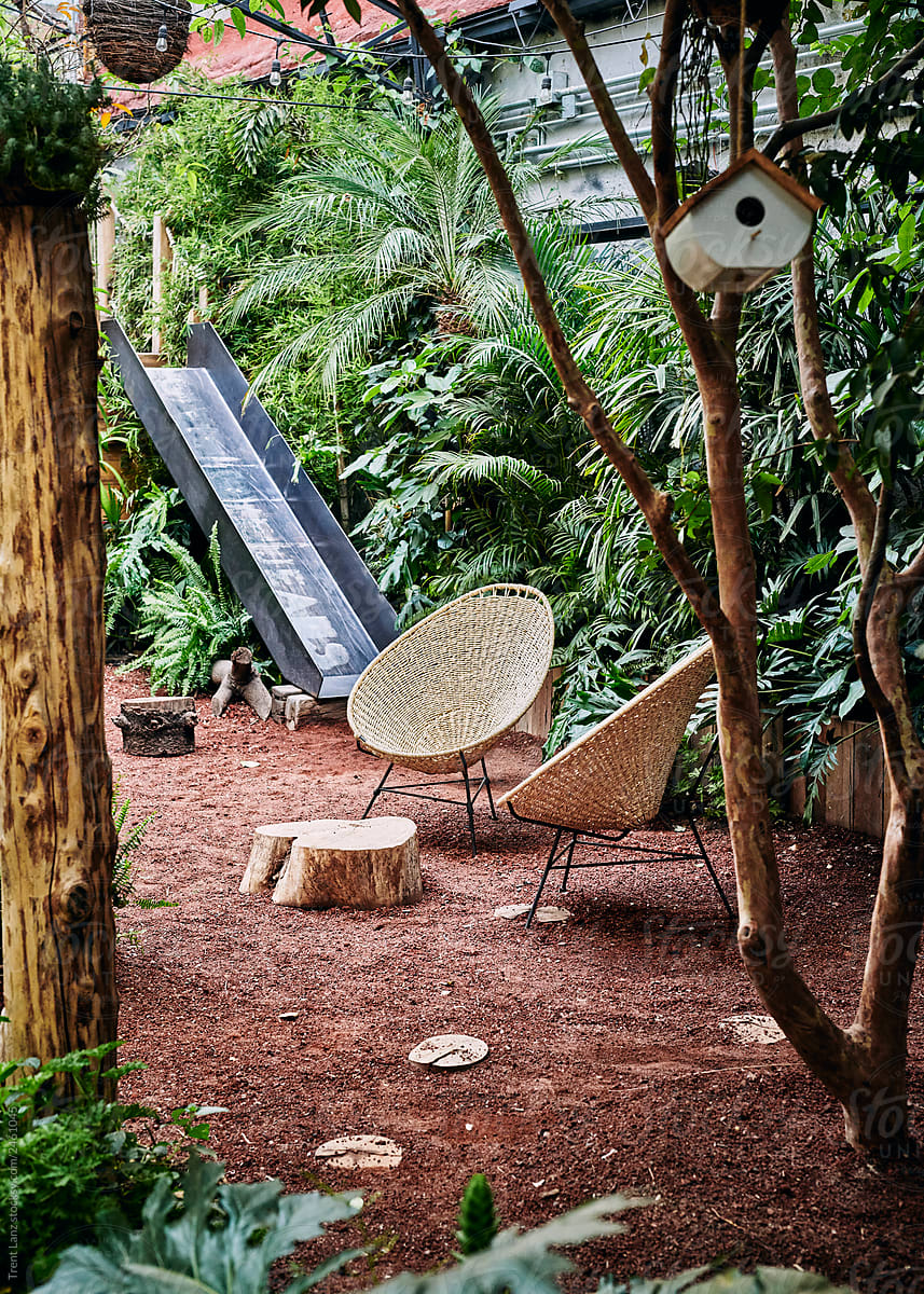 Modern seats in garden with playground