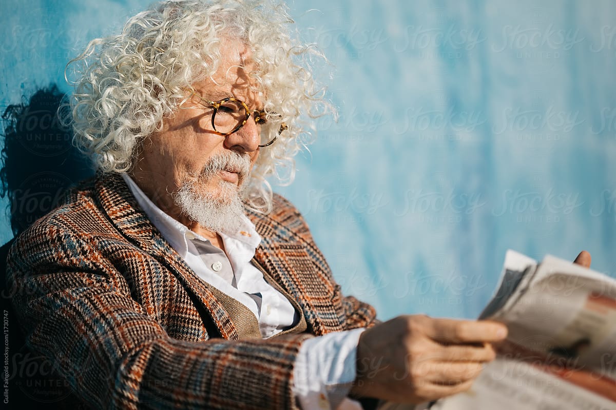 elderly man reading newspaper