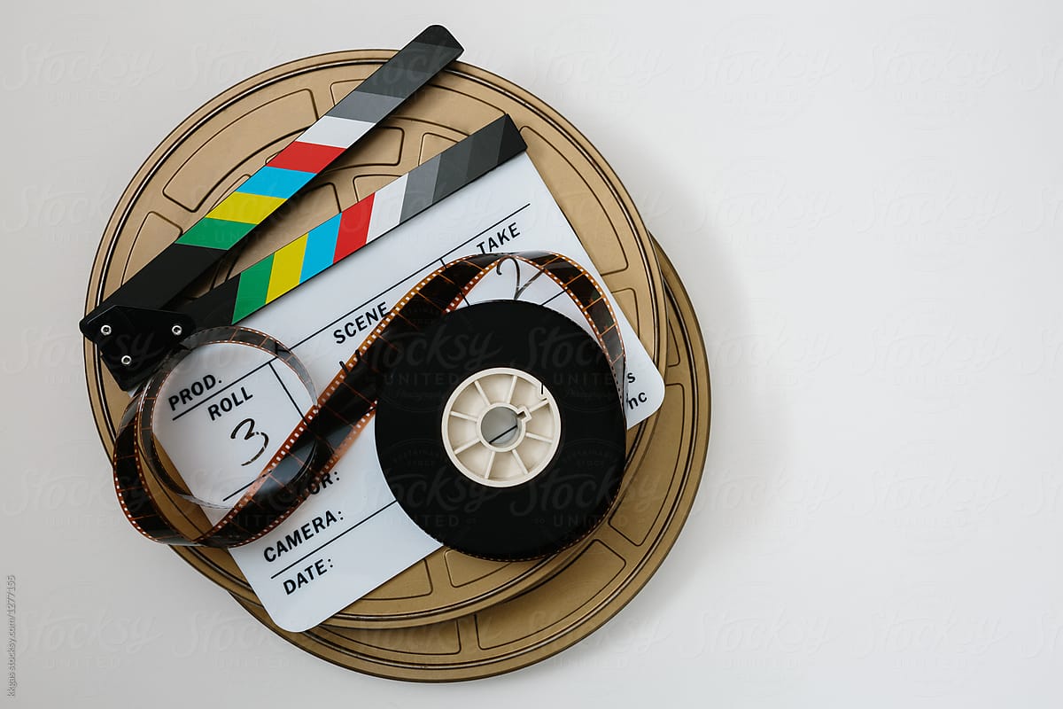 Clapperboard With 35mm Film Reel by Stocksy Contributor Kkgas