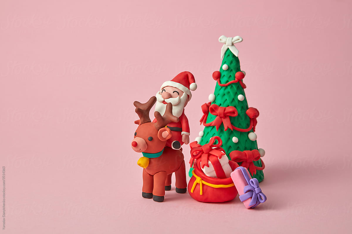 Craft plasticine Santa Claus ride a deer with gifts.