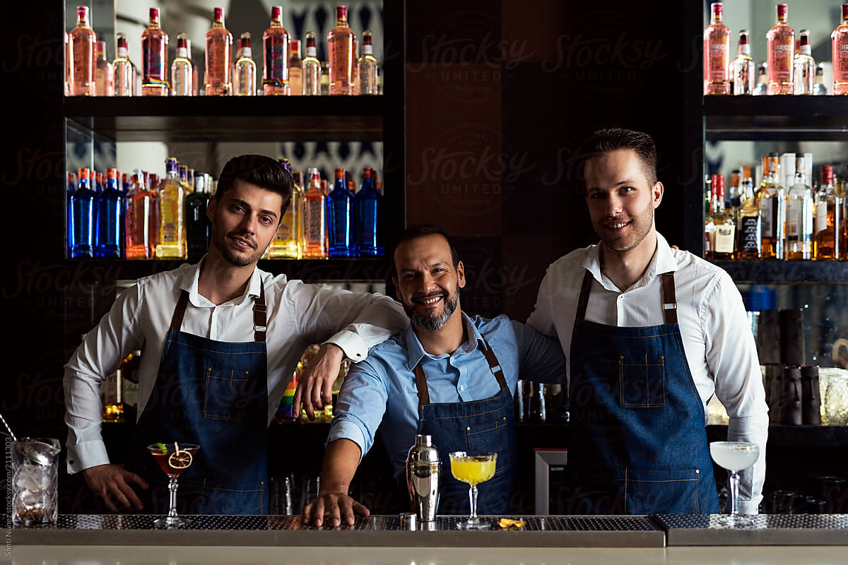 Professional team of young bartenders working