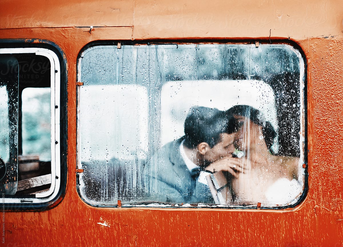 Beautiful couple kissing on the rainy day
