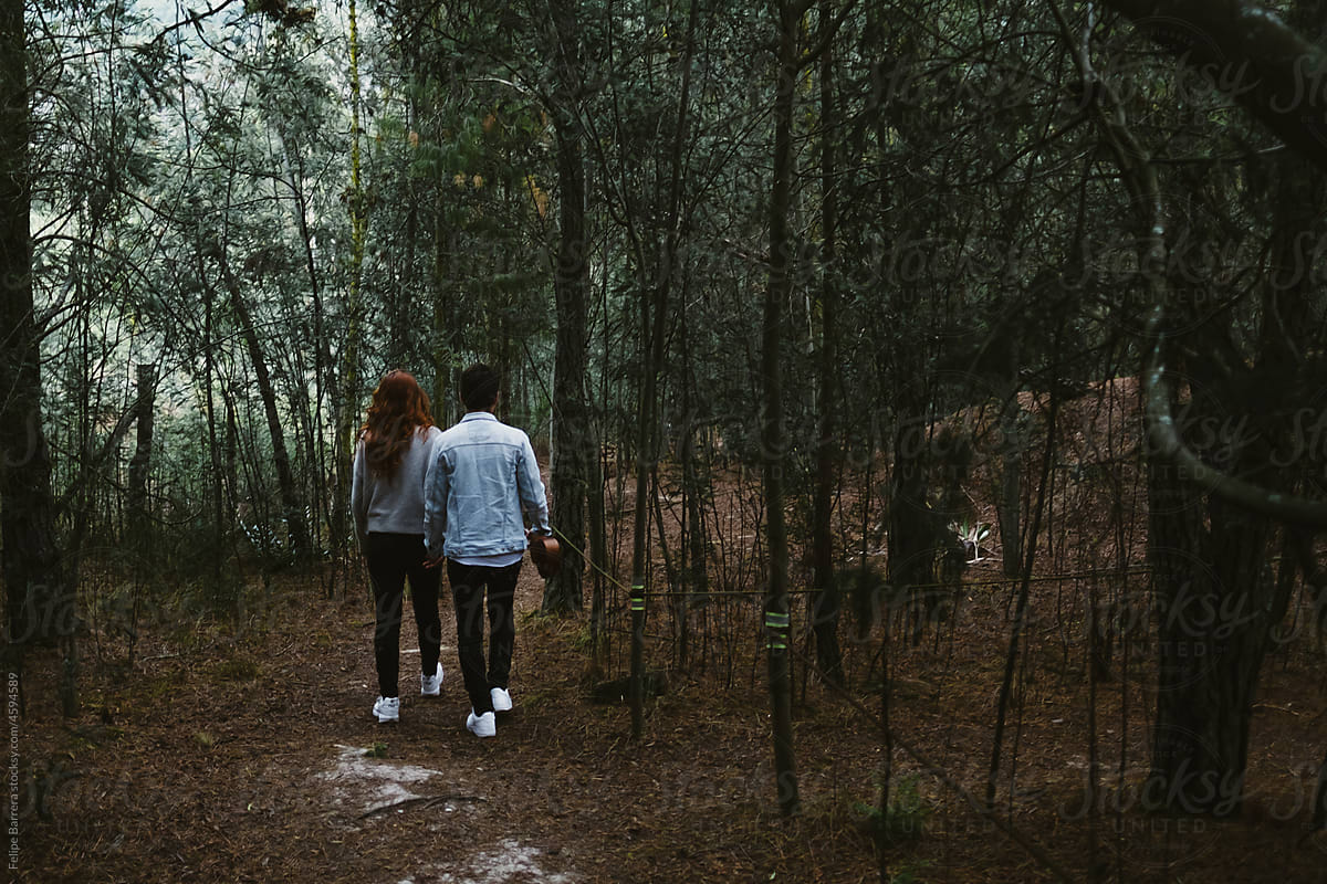 Couple Walking In The Forest