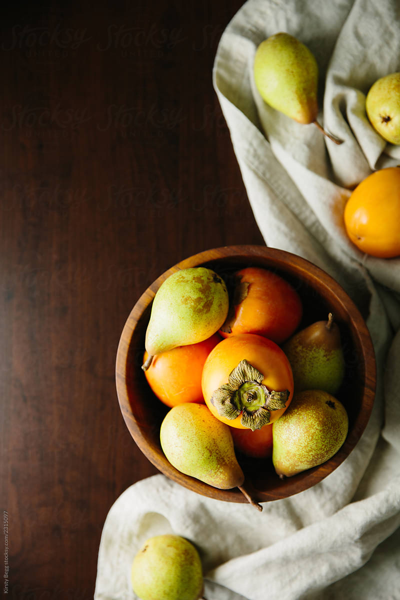 Persimmon and pear in fruit bowl
