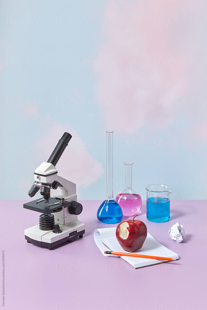 Microscope, red apple and test tubes