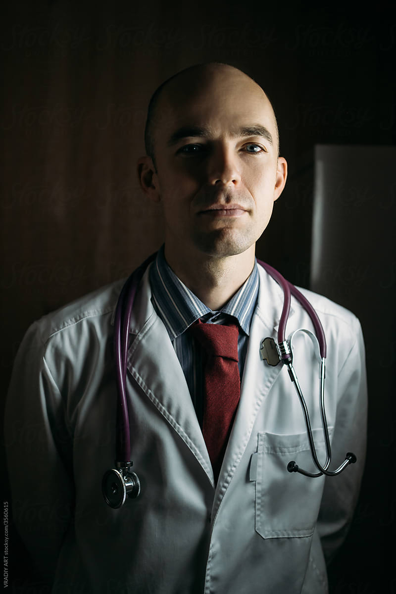Male doctor in dark office