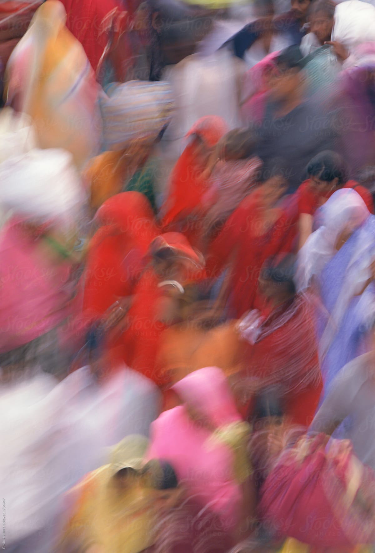 Blurred motion, crowd of people in colourful Saris, New Delhi, Delhi, India