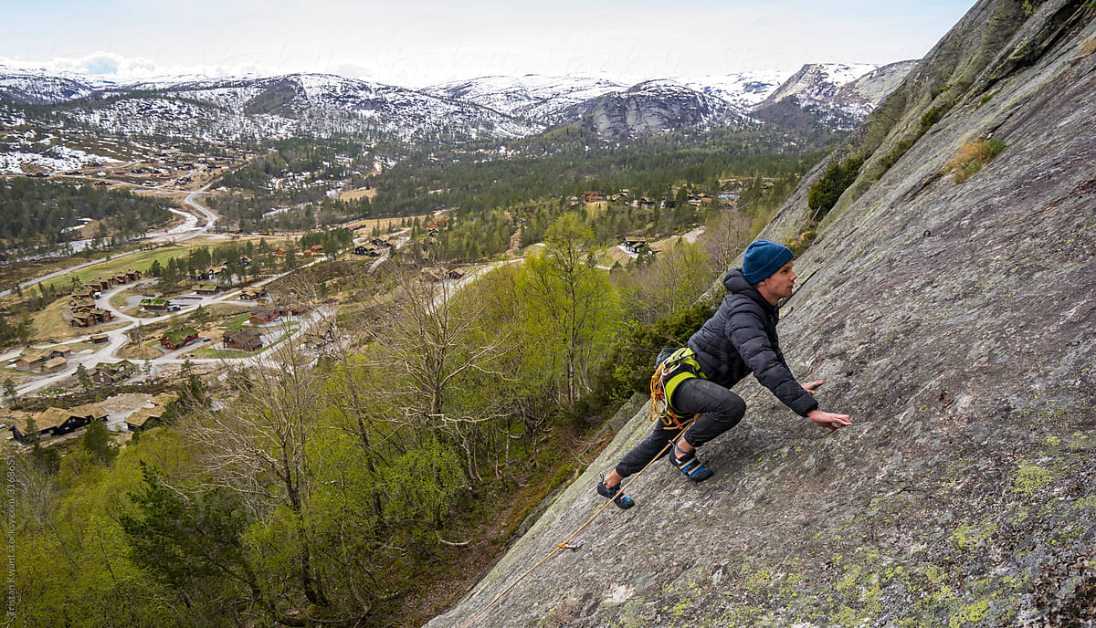 Rock climbing on granite near alpine village