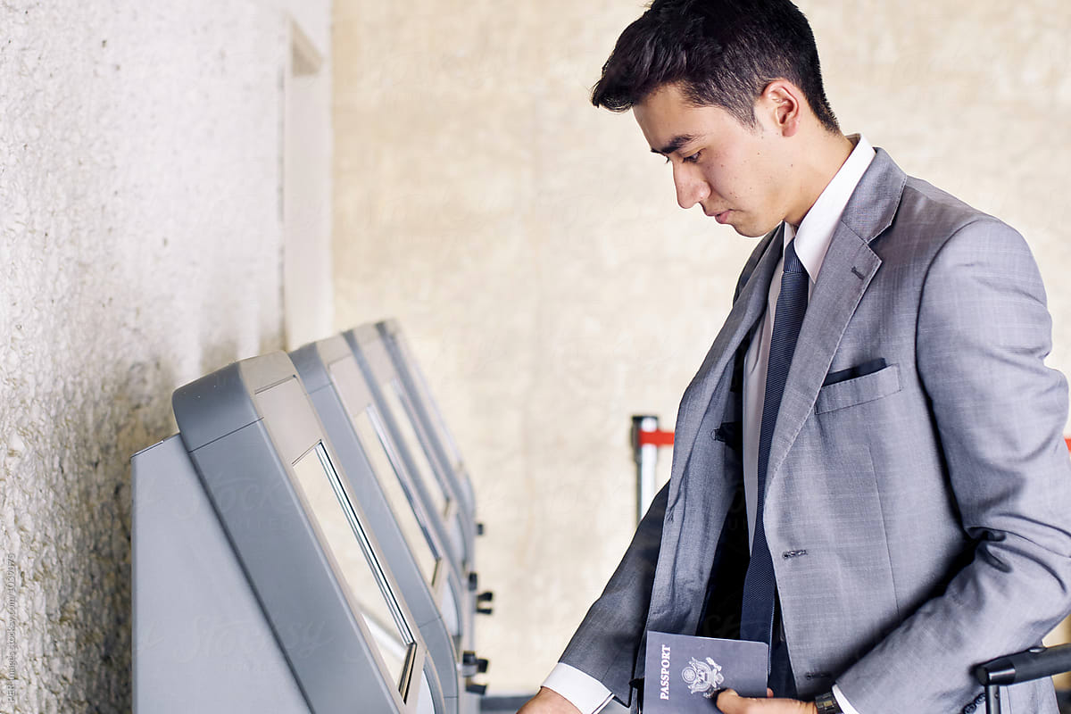 Airport business man travel: airport ticket machine with business man