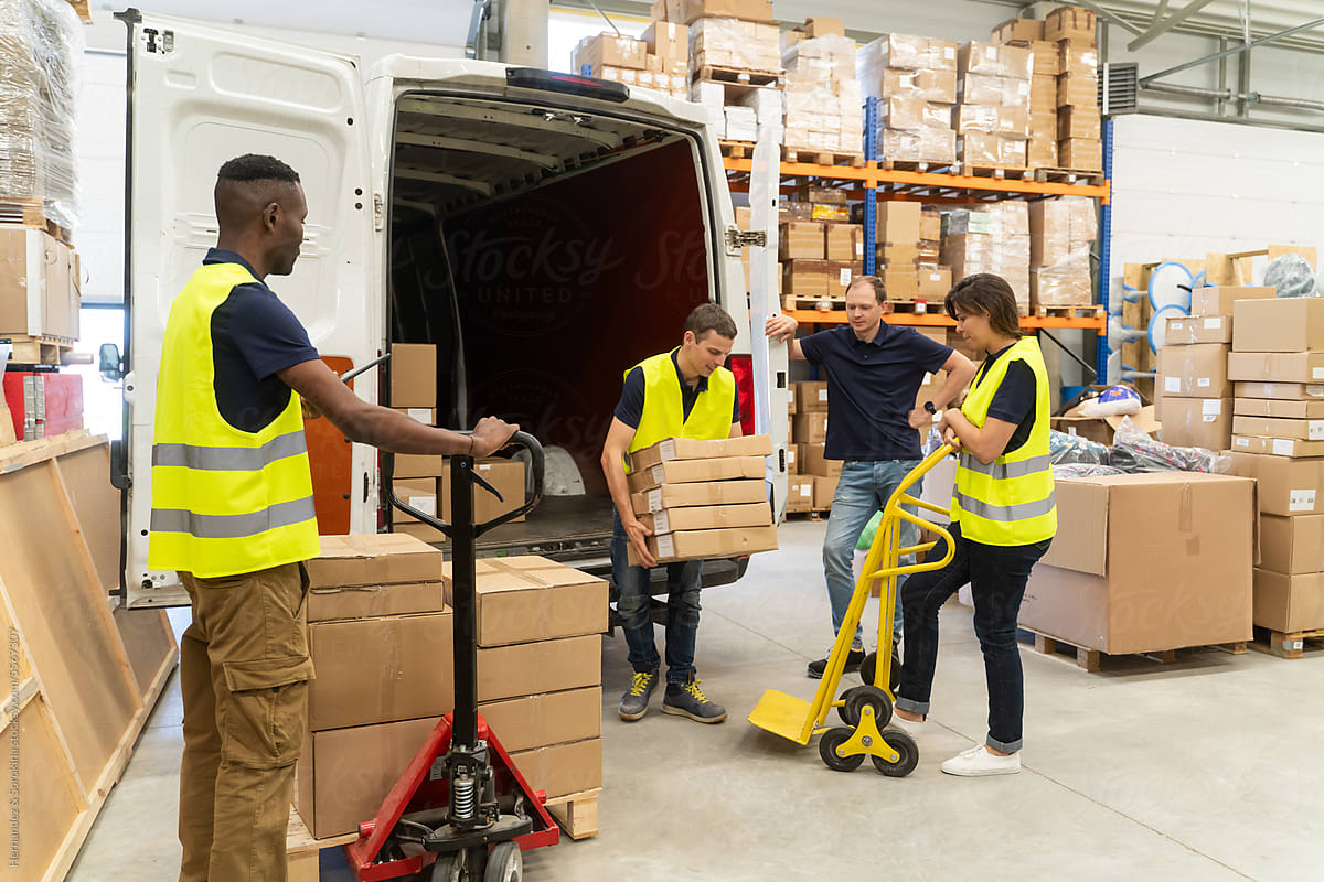 Busy Warehouse Workers Unloading Delivery Van