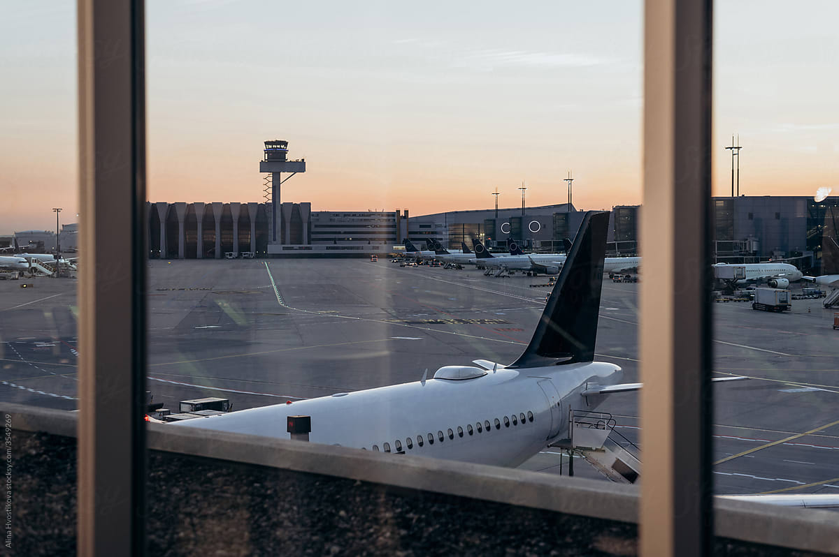 Airfield behind window during sunset