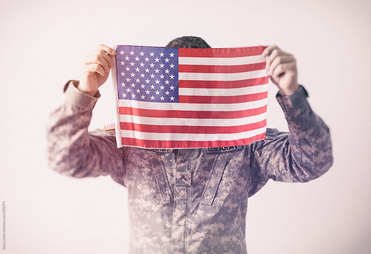 Military: Man Holding Up United States Flag