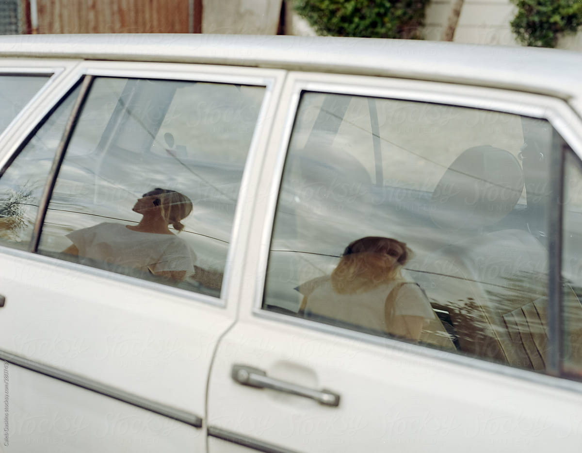 Portrait of two women on car window