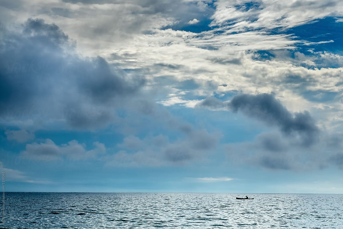 Single Canoe on Lake with Clouds