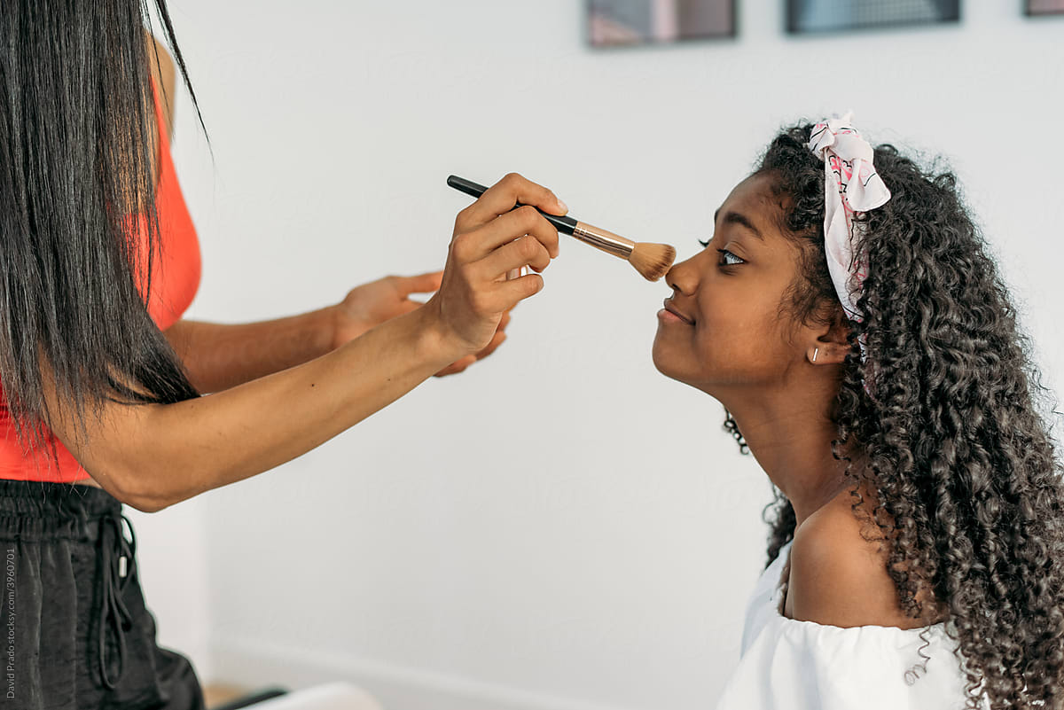 Black mother and daughter doing makeup