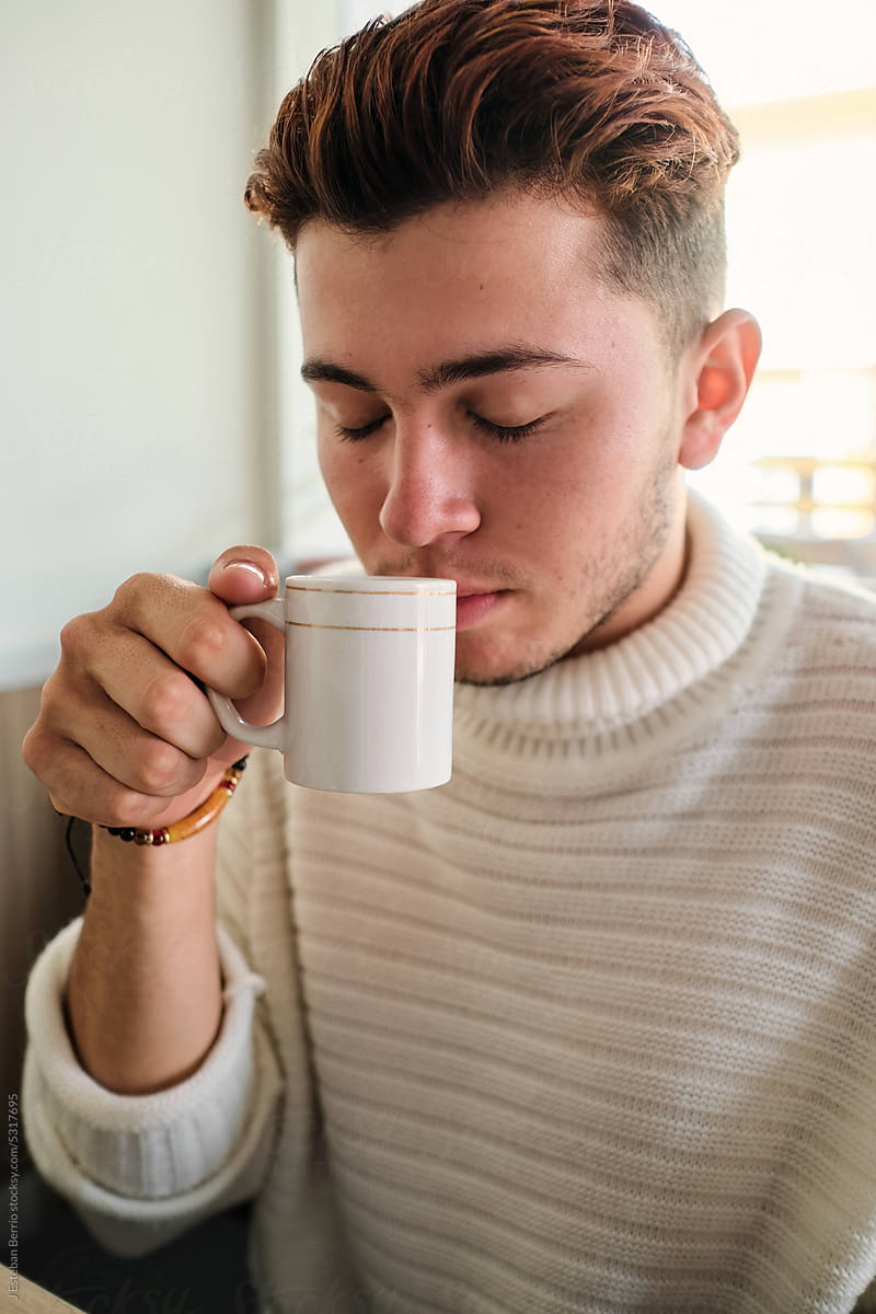 Person enjoying a cup of coffee