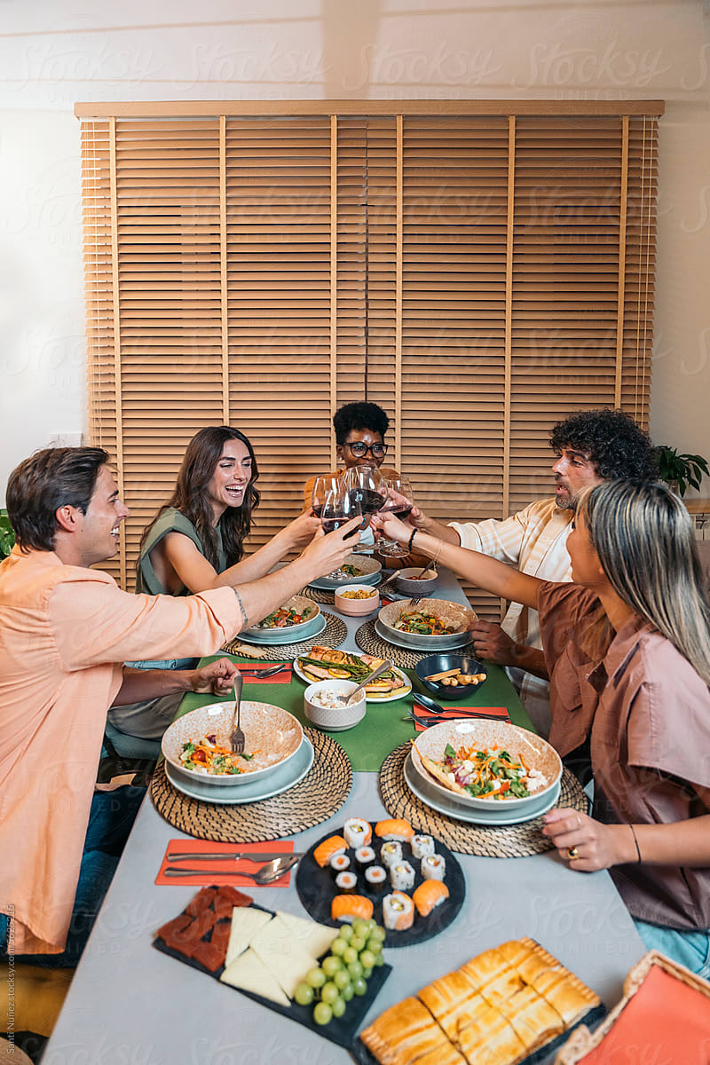 Top View Of Group Of Diverse Friends Clinking Wine Glasses